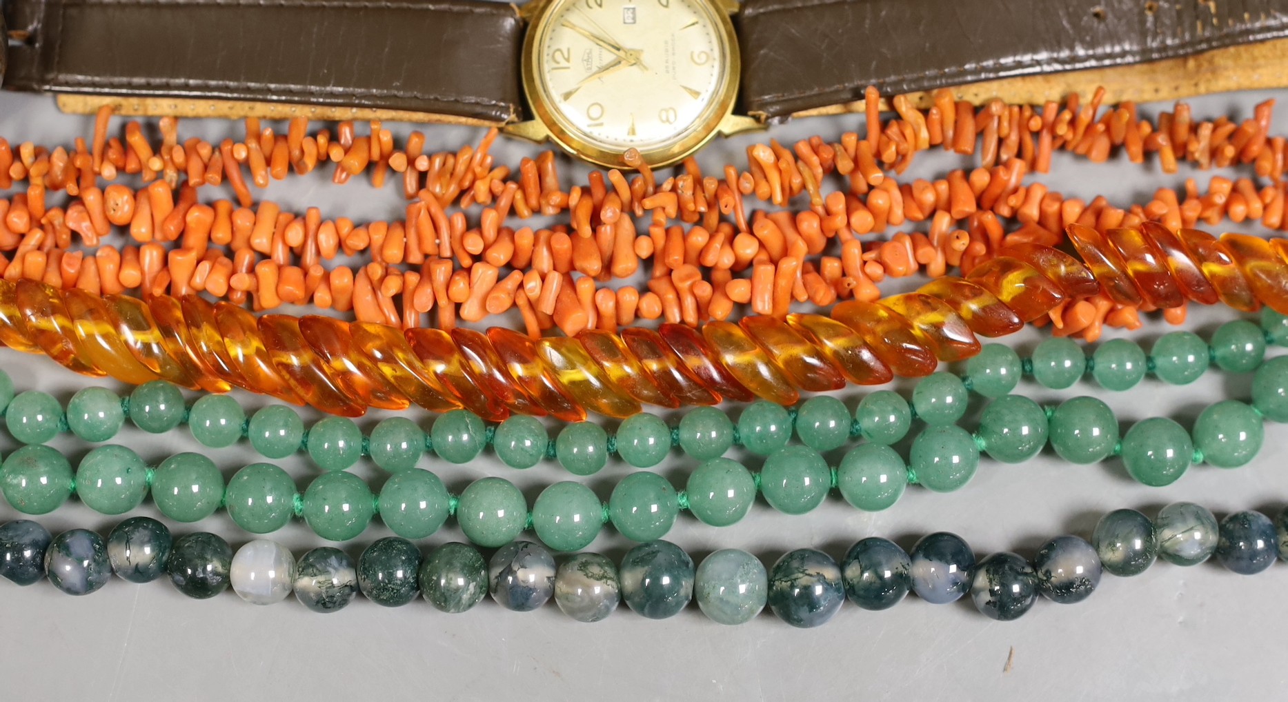 Sundry jewellery including two adventurine quartz necklaces, a moss agate bead necklace, two jagged coral necklaces, an amber necklace, paste brooch, a German 800 standard white metal pocket watch and a steel and gold pl